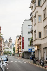 a city street with buildings and bikes parked on the sidewalk at City Hotel Mercator in Frankfurt/Main