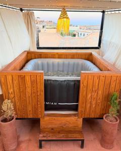 a hot tub in a room with a window at Dar Skouri 51 in Marrakesh