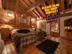 a bedroom with two beds and a sign that says pleasered the most trouble at Luxury Chalet Corvara with Pool & Gym in Colfosco