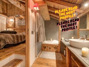 a bathroom with a sink and a bed in a room at Luxury Chalet Corvara with Pool & Gym in Colfosco