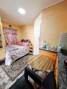 a small room with a table and a bed at EMME Escape in Saint Georgeʼs