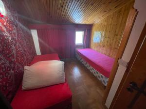 a small room with two beds and a window at Villa Di Micco in Pescasseroli