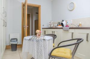 a kitchen with a table with a table cloth on it at Alder House Studio in Killarney