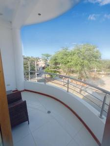 a balcony with a chair and a view of a street at Casa Premium Talara in Talara