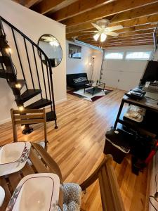 a living room with wooden floors and a ceiling at NYC-Style Loft with Secret Entrance - Just 6 Miles from Times Square in North Bergen
