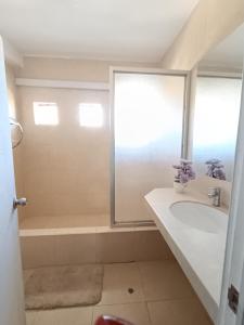 a bathroom with a tub and a sink and a shower at Casa Premium Talara in Talara