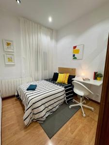 a bedroom with a bed and a desk in it at Acogedora habitación en barrio madrileño con encanto in Madrid