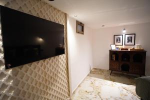 a living room with a large flat screen tv on a wall at Le Loft Bleu in Rabat