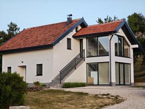 a white house with a red roof at Kuća za odmor Rosa in Tomislavgrad