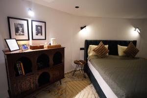 a bedroom with a bed and a side table at Medina Loft Your Artistic Escape in Rabat