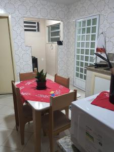 a dining room table with a red table cloth on it at Aunt A CASA DOS SONHOS DA TIA LETÍCIA in Miguel Pereira
