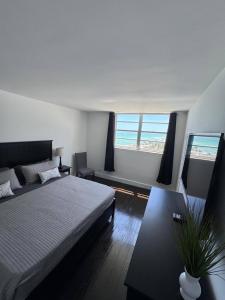 a bedroom with a bed and a view of the ocean at Beachfront 2BR at The Tides | EPIC Stay in Hollywood +76 photos