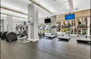a gym with treadmills and elliptical machines at Beachfront 2BR at The Tides | EPIC Stay in Hollywood