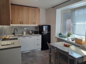 a kitchen with a black refrigerator and a table at UH byt 15 in Uherské Hradiště