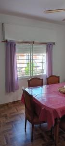 a dining room with a pink table and chairs at Rentals Temp - Deptos in San Clemente del Tuyú