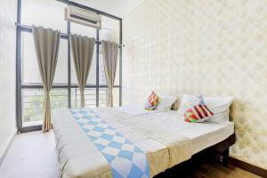 a bedroom with a bed and a large window at Hotel O Together in Bengaluru +31 photos