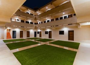 a large room with green grass in the middle at Hotel Pakal 58 Centro in Mérida +21 photos
