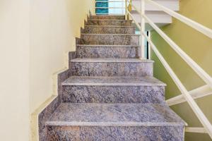 a staircase in a house with granite steps at Super Hotel O Together in Bengaluru