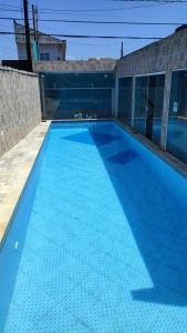 Una gran piscina azul en la parte superior de un edificio en Casas para Temporada RS, en Praia Grande