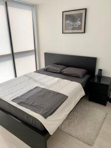 a large bed in a bedroom with a window at Luxury Suites In Good Location in Richmond Hill
