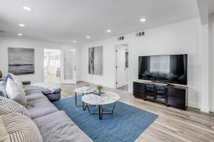 a living room with a couch and a tv at Vacation House with Pool in Garnsey