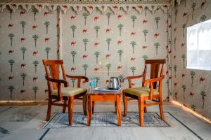 a dining room with a table and two chairs at Grand Inara Camp in Jaisalmer
