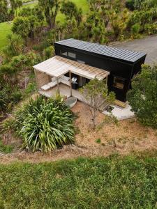 an overhead view of a building with a picnic table at Hahei Tiny Home - Outdoor Bath in Hahei +9 photos