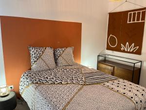 a bedroom with a large bed with a brown headboard at Fleur de Paradis in Saint-François +12 photos