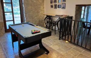 a ping pong table in a living room with a table at Cozy Home In Labin in Strmac
