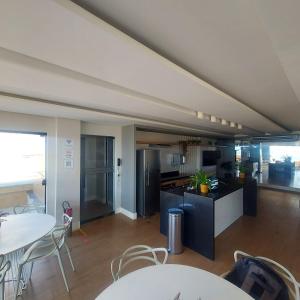 a kitchen and dining room with tables and chairs at Residence Scala in Fortaleza +19 photos