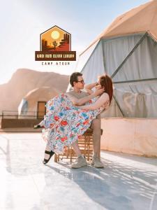 a man and a woman standing on a dance floor at WADI RUM OLIVIA LUXURY CAMP & tour in Wadi Rum
