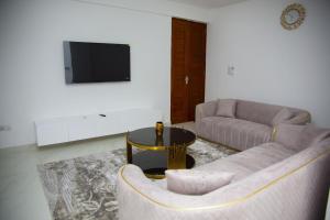 a living room with a couch and a table at Havah Zanzibar Home in Mwanakwerekwe