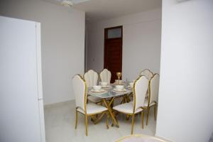 a dining room with a table and chairs at Havah Zanzibar Home in Mwanakwerekwe