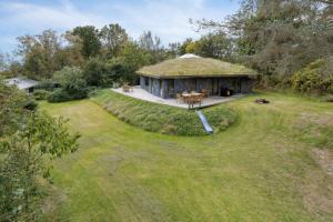 a large house with a grass roof on a field at Scenic 2025 Summer House With Sea View in Dokkedal