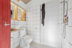 a white bathroom with a toilet and a shower at Scenic 2025 Summer House With Sea View in Dokkedal