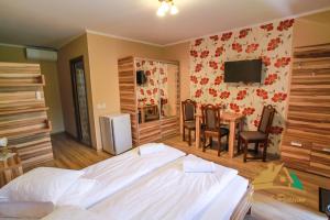 a bedroom with a bed and a table with chairs at Németh Resort in Sovata