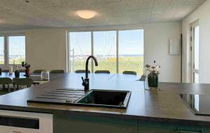 a kitchen with a sink and a large window at Cozy Home In Haderslev With Wifi in Haderslev
