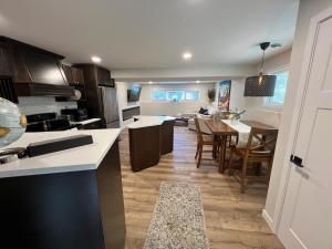a kitchen and living room with a table and chairs at The West Wind Retreat in Lethbridge +21 photos