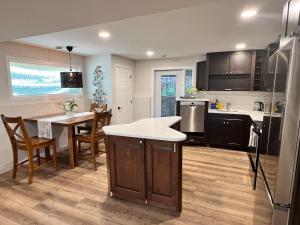 a kitchen with a table and a dining room at The West Wind Retreat in Lethbridge