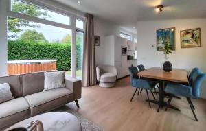 a living room with a couch and a table at 2 Bedroom Cozy Home In Heinkenszand in Graszode