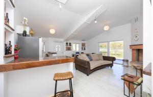 a living room with a couch and a table at Stunning Home In Trogir in Prapatnica +8 photos