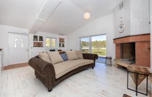 a living room with a couch and a fireplace at Stunning Home In Trogir in Prapatnica +7 photos