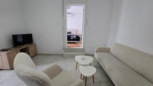 a living room with a couch and a table at Bazen za uzivanje in Petrovaradin