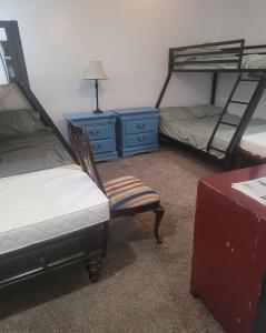a room with two bunk beds and a chair and a desk at PalmBeachLake&PoolFrom69dollarsForPersonDayly 