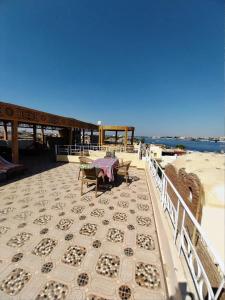 a patio with a table and benches on the beach at Nagar Villa For Rent in Luxor +248 photos