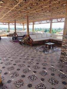 a large room with couches and tables in a building at Nagar Villa For Rent in Luxor