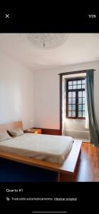 a bedroom with a bed and a window at Solar do Sebolido in Sebolido