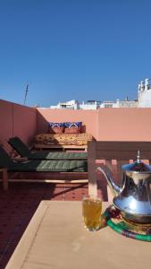 a table with a teapot and a cup on a balcony at La casa de Oasis in Essaouira