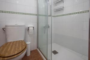 a bathroom with a toilet and a glass shower at Valverde central Isla del Hierro in Valverde +55 photos