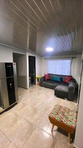 a living room with a couch and a refrigerator at Vélez Loft II in Vélez